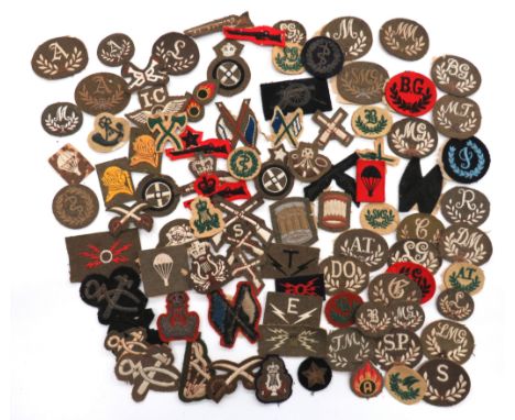 90 x Cloth Trade Badgesembroidery examples within a wreath include BG ... SMG ... M ... B ... TM ... AT ... DO ... LG ... C .
