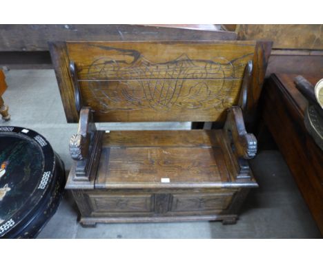 A carved oak monk's bench 