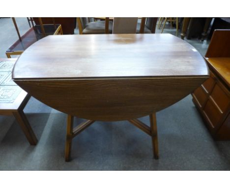 An Ercol drop-leaf dining table 