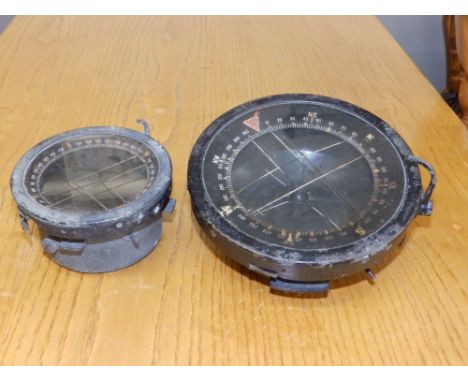 A black bakelite gimballed compass Type P10 (?) NO. 30705B , 6.6" diameter and a smaller, metal compass, 4.5". (2)