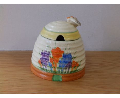 A Clarice Cliff Newport Pottery Crocus pattern beehive honey jar, 3.5" high.