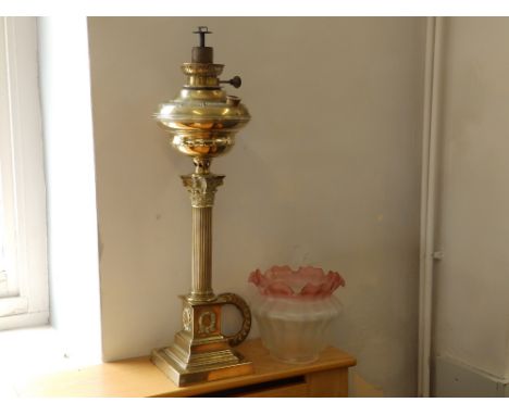 A German Veritas brass corinthian column oil lamp, 25" high excluding associated shade.