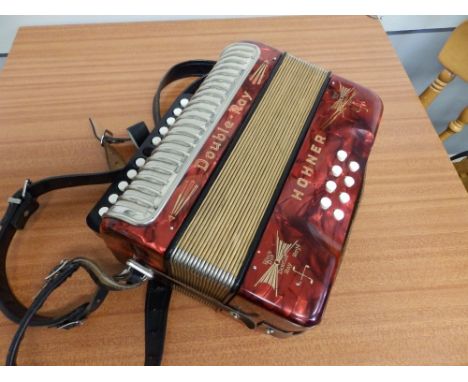 A Hohner Double Ray Black Dot accordion.