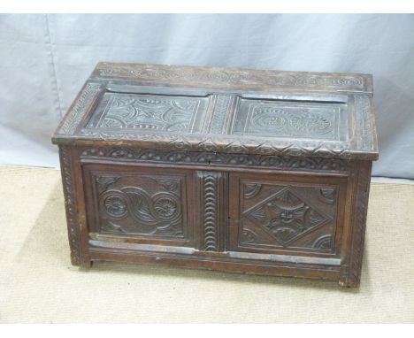 A 17th/18thC carved oak two panel trunk with interior nine division cellarette style compartment, W90 D54 H49cm