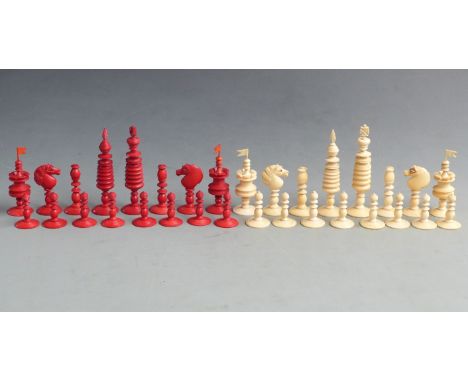 A 19thC turned ivory chess set with one side stained red, height of king 13cm.&nbsp;