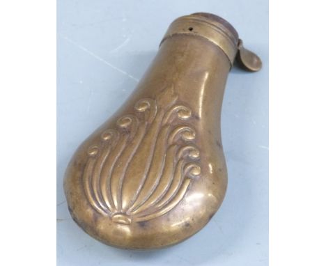 Copper and brass pistol or revolver powder flask with embossed decoration to both sides, 19cm long. 