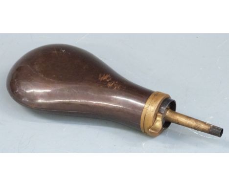 Copper and brass powder flask with embossed decoration to one side, 20cm long. 