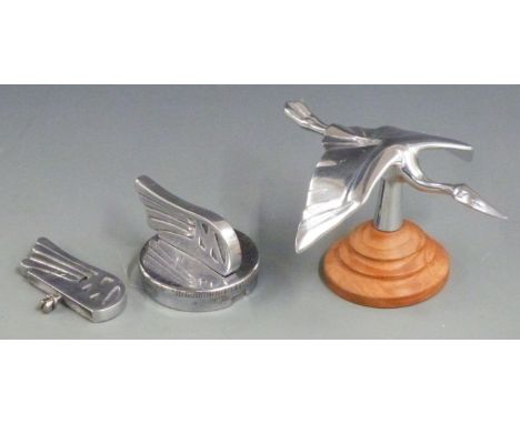 Morgan stork aluminium car mascot on turned wooden base, length 16cm together with a winged M mounted on radiator or similar 