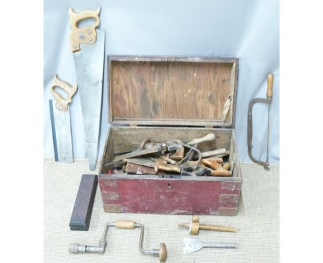 A metal bound trunk containing vintage tools including woodworking saws, Marsden Brothers saw, bit and brace, large quantity 
