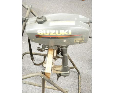 Suzuki 2 Horsepower outboard motor boat engine on wheeled stand