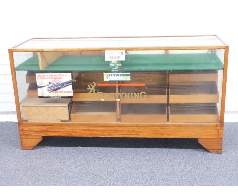 An early/mid 20thC glazed oak haberdashery/shop fitting display cabinet with interior waterfall drawer, display shelf and bra