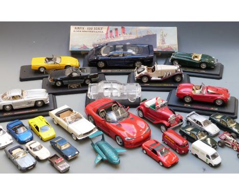 Twenty-one Corgi, Dinky, Burago, Maisto and similar diecast model vehicles including Whizzwheels, Thunderbirds etc, some on d