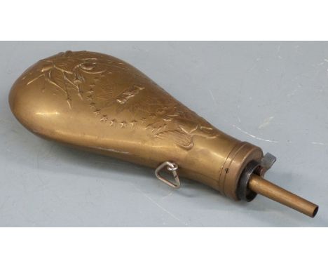 Brass powder flask with embossed decoration and 'US' shield to both sides, 23.5cm long. 