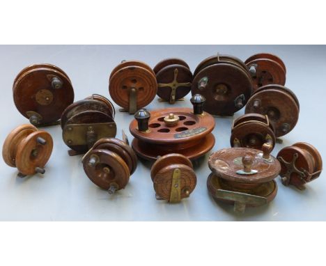 Fifteen vintage wooden and brass fishing reels including some with early ratchet mechanism, drag and lineguards, two named Mi