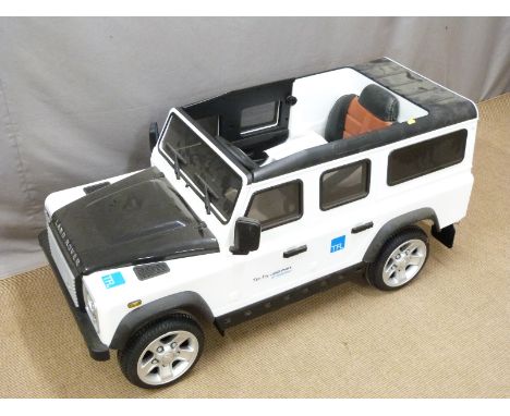 Child's electric Land Rover Defender ride on toy car with parental remote control, LED lights, power indicator display, real 