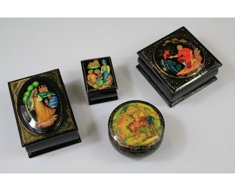 20th Century Hand Painted Russian Boxes. The four boxes painted with scenes from Russian folk-lore or fairy-tails. The first 