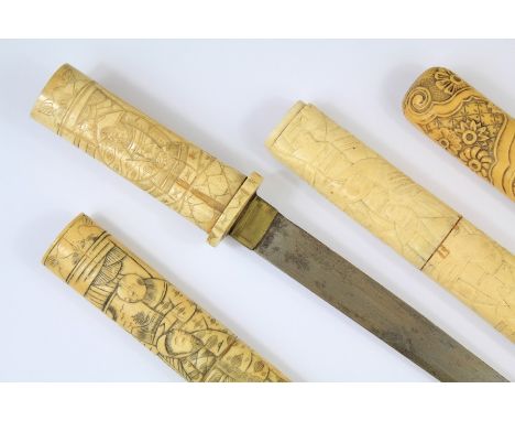 A Japanese Ivory Tanto (Dagger). The Tanto handle and scabbard carved with figural and floral decoration, the blade approx 21