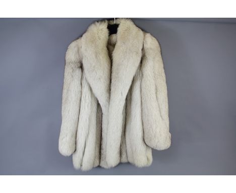 A Lady's Arctic Fox Fur Coat. With pink lining, approx 82 cms (lining unstitched to collar)