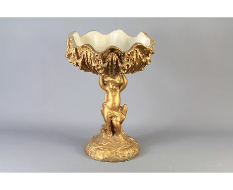 A Vintage Ceramic Fruit Bowl. The bowl modelled as an oyster shell supported by a cherub, approx 38 cms.