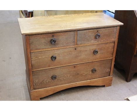 An Oak Arts &amp; Crafts Chest of Drawers. The chest of drawers having two short and two long drawers with copper ring handle