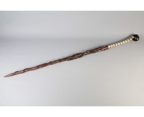 A Solomon Islands Chieftain Stick. The stick carved with totemic animals and heightened with mother of pearl to the upper por