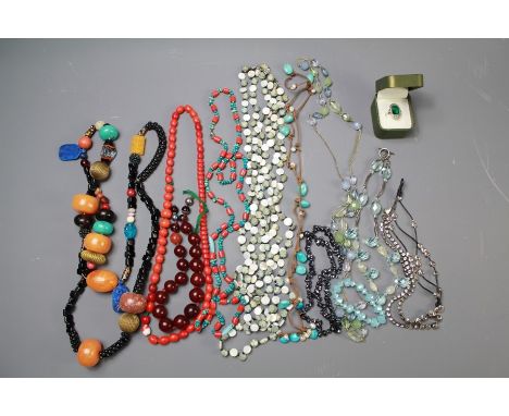 A Box of Costume Jewellery. This lot includes an amber and coral-style necklace, glass necklaces with silver green-stone ring