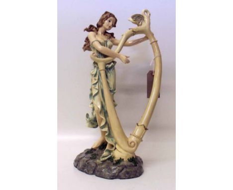 Resin figureen of young woman playing a harp. Condition report: see terms and conditions