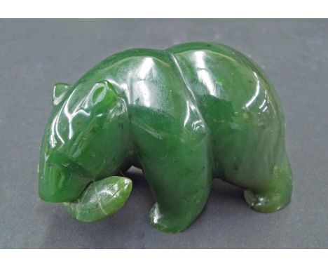 Chinese carved hard green stone (possibly jade) study of a bear with a fish in its mouth, 3" long