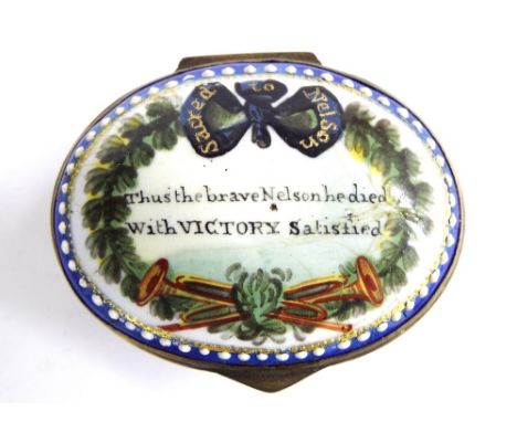 18th century Bilston type in oval enamel patch box, the hinged lid painted with a tied ribbon and crossed trumpets within a w