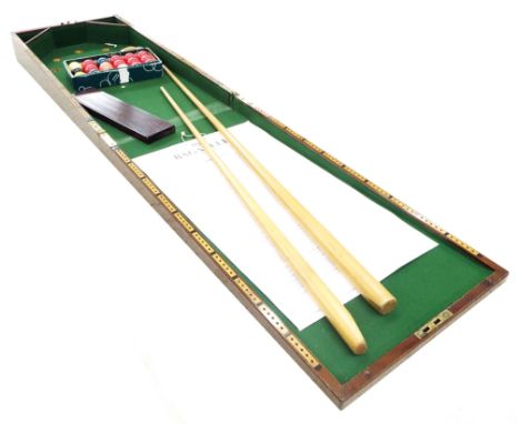 Mahogany folding Bagatelle board with green baize interior, with various balls and cues, the board 60" extended