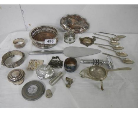 A mixed lot of silver plate including wine coaster, flatware etc.,