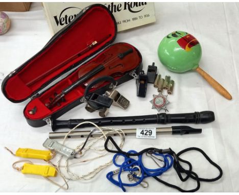 A mixed lot of whistles, recorder, maraca, mini violin and a penny whistle etc.
