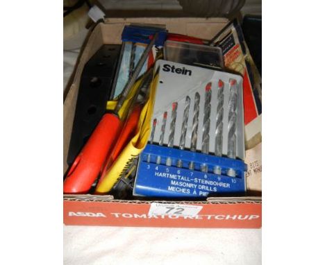 A mixed lot of tools including new drill bits.