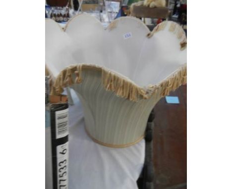 A large hooped frame lamp shade for a standard lamp. 