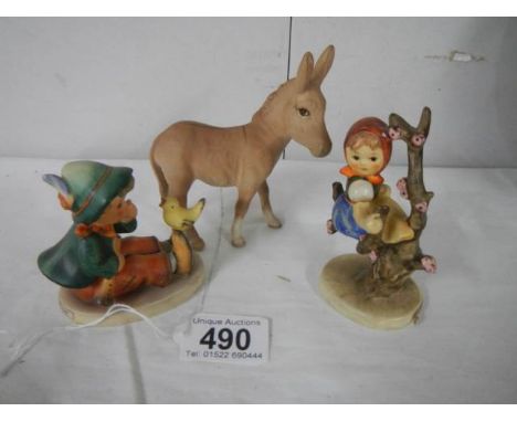 A Beswick donkey and two Goebel figures. 