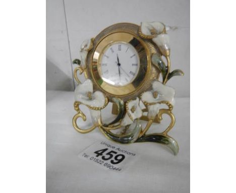 A Peace Lily decorated mantel clock. 