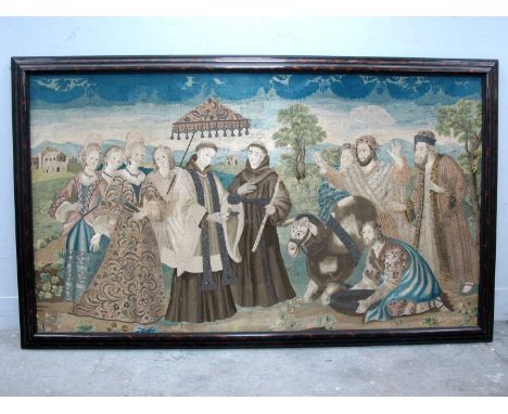 A XIX Century Continental Silk Crewel Work Tapestry Picture, depicting monks and other figures in a landscape with cottages a
