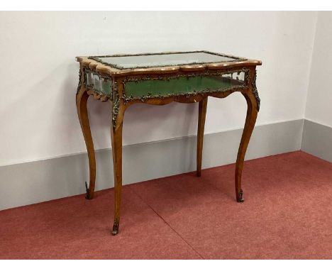 A XIX Century French Serpentine Shaped Kingwood Bijouterie Cabinet Table, the hinged top and all four sides with bevelled gla