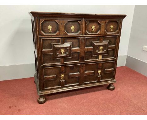 A XVII Century Oak Chest of Drawers, the two short and two long drawers with moulding on bun feet, 115cm wide.