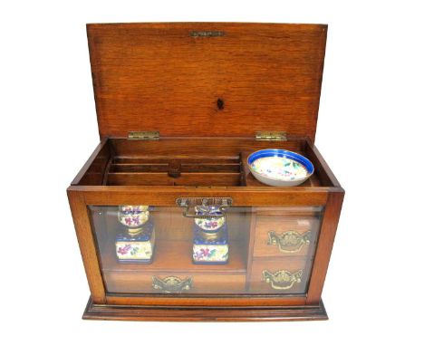 An Early XX Century Travelling Oak Writing Box, the glass fall front and lift-up lid opening to reveal a stationary rack, thr