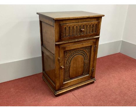 A XVII Century Style Oak Side Cabinet, the drawer with knulled decoration over a cupboard door with arched decoration, on sti