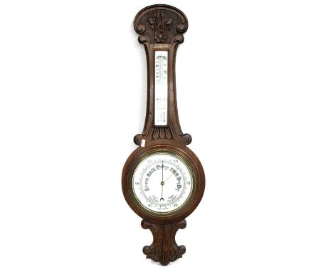 A Late XIX Century Oak Cased Wall Barometer, with leaf carved decoration, circular white enamel dial and separate thermometer