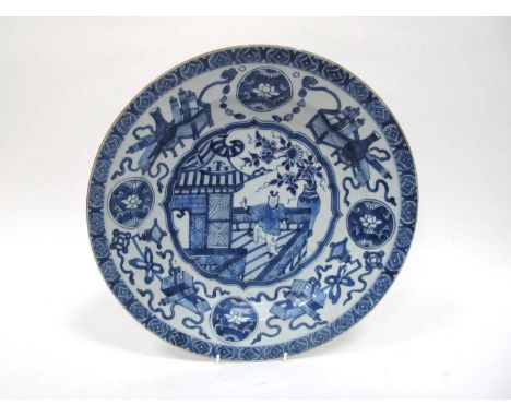 A XIX Century Chinese Porcelain Charger, painted in blue with a central figure on a terrace within a border of flowers, scrol