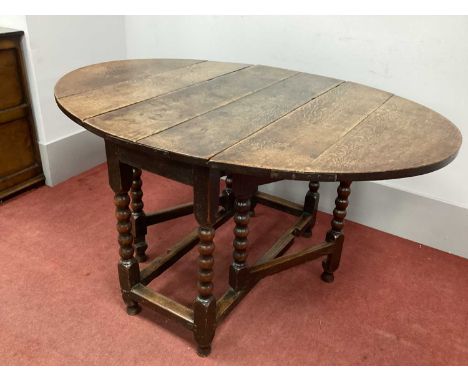 A Late XVII Century Joind Oak Drop Leaf Table, with single drawer, on bobbin and block supports, 76cm high.
