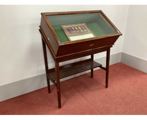 A XX Century Mahogany Display Cabinet, with hinged sloping glazed top to baized interior with a display of a framed replica s