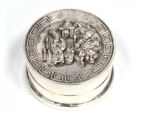 A Chinese Silver Circular Trinket Box and Cover, cast with figures and a pagoda within a key pattern border, character mark t