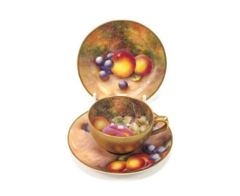 A Royal Worcester Porcelain Cabinet Cup and Saucer, painted by Freeman and another, with ripening fruit against a mossy woodl