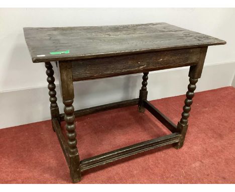 A XVII Century Joined Oak Side Table, raised on bobbin and block supports united by stretchers, 86cm wide.