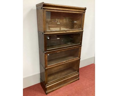 A Globe Wernicke Oak Four High Sectional Bookcase, (bearing label), on a shaped plinth base, 160cm high, 86cm wide.Polish los