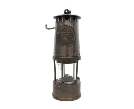 A Miners Lamp, by 'The Protector Lamp and Lighting Co. Ltd, Eccles' type SL, 24cm high (handle down).